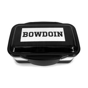 Black & white bento box with white rectangle with black BOWDOIN imprint on lid.