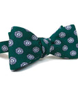 Deep green silk bow tie with all-over print of Bowdoin College seal.