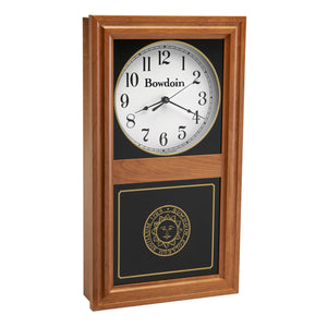 Autumn finish wall clock with clock face in upper inset in white with a Bowdoin wordmark and Arabic numerals, and a Bowdoin College seal in gold on the lower glass. 