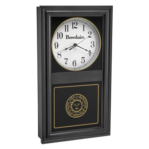 Black finish wall clock with clock face in upper inset in white with a Bowdoin wordmark and Arabic numerals, and a Bowdoin College seal in gold on the lower glass. 