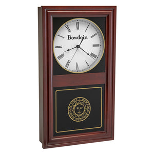 Burgundy finish wall clock with clock face in upper inset in white with a Bowdoin wordmark and Roman numerals, and a Bowdoin College seal in gold on the lower glass. 