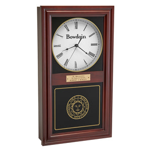 Burgundy finish wall clock with clock face in upper inset in white with a Bowdoin wordmark and Roman numerals, and a Bowdoin College seal in gold on the lower glass. Optional brass engraved plaque is shown on midrail.