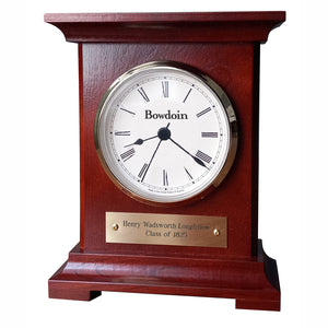 Burgundy finish wooden desk clock with white and brass dial, black Roman numerals, and BOWDOIN wordmark. Brass plaque showing personalization has Henry Wadsworth Longfellow Class of 1825 engraved on two lines.
