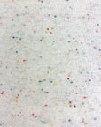 Closeup of white fabric with multicolored speckles