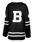Back of black hockey jersey with a large white 'B' on the back, displayed on a white background.