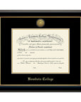 Diploma frame with glossy black moulding with gold fillet and black and gold matting. Gold sun seal medallion set into the mat on top of the diploma, BOWDOIN COLLEGE embossed in gold below.