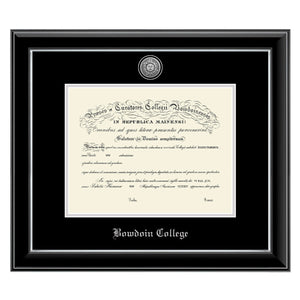 Diploma frame with glossy black moulding with silver fillet and black and silver matting. Silver sun seal medallion set into the mat on top of the diploma, BOWDOIN COLLEGE embossed in silver below.