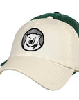 Off-white and hunter green ball caps with embroidered polar bear medallion.
