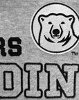 Close-up of a gray heather fabric with black embroidered text and a circular polar bear logo patch.