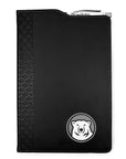 Black leatherette journal with mascot medallion imprint on lower left corner. Cutout in cover on top shows a retractable Bowdoin-imprinted pen in an elastic pen loop.