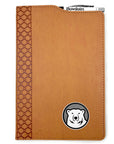 Brown leatherette journal with mascot medallion imprint on lower left corner. Cutout in cover on top shows a retractable Bowdoin-imprinted pen in an elastic pen loop.