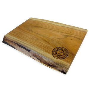 Natural wood cutting board with live edges on top and bottom, engraved Bowdoin College sun seal in lower right corner.
