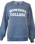 Women's long sleeved crewneck sweatshirt with front pouch pocket and white BOWDOIN arched over COLLEGE chest imprint in stonewash blue.