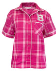 A women's short-sleeve button-front shirt in a pink and white plaid pattern, featuring a collar, white piping, a chest pocket, and a large white block letter 'B' on the left chest.