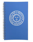 A blue spiral-bound notebook featuring a white printed circular seal with a sun face and the text 'BOWDOIN COLLEGII SIGILLUM 1794' on the cover, shown against a plain white background.
