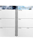 An open spiral-bound planner or agenda with lined daily sections from Monday to Sunday on both pages, shown against a plain white background.