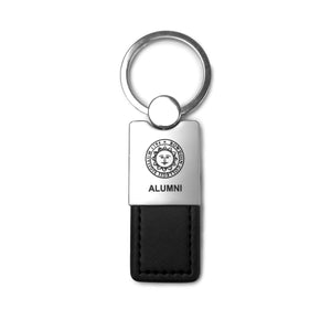 Metal key tag with engraved Bowdoin seal over ALUMNI, and a black leather fob.