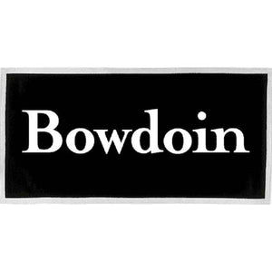 Rectangular black felt banner with white trim and brass grommets in the upper corners. A large BOWDOIN wordmark is imprinted on it in white.