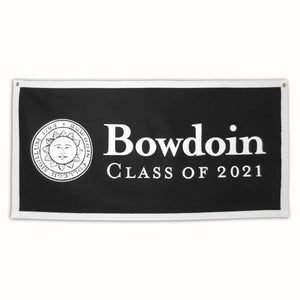 Black oblong felt banner with white trim. White Bowdoin sun seal on left side, right side has white imprint of BOWDOIN wordmark over CLASS OF 2021.