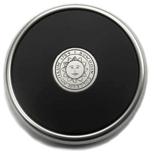 Round black leather coaster with silver rim and silver engraved Bowdoin sun seal in center.
