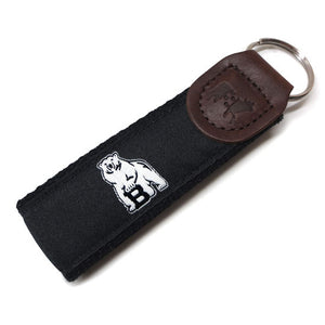 Black web key fob with leather cap and black silk ribbon with woven white polar bear mascot.