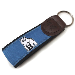 Black web key fob with leather cap and blue silk ribbon with woven white polar bear mascot.