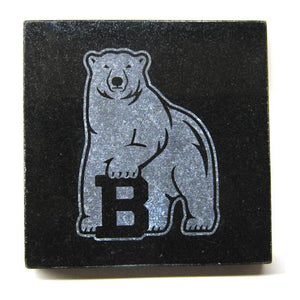 Square black granite coaster with etched polar bear mascot.