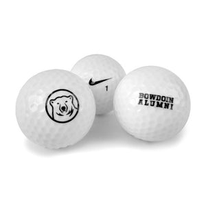 3 golf balls. One with mascot medallion, one with Nike swoosh, one with BOWDOIN ALUMNI imprint.