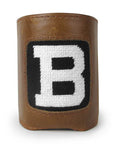 Leather can cooler with needlepoint inset of large white B in black ground.