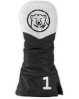 Black golf club cover with inset number 1 in white needlepoint in lower right corner, tip is white needlepoint with black Bowdoin mascot medallion.
