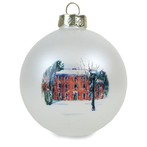 Pearl white bulb ornament with print of painting of Mass Hall in the snow.