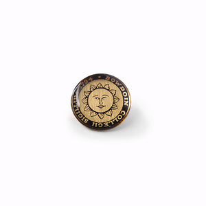 Small tie pin with the Bowdoin College sun seal cabochon in black and gold.