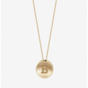 Gold necklace with small gold pendant engraved with a B.