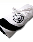 White waffle-knit blanket with embroidered mascot medallion patch. Black trim.