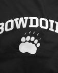 Black quilt panel with white Bowdoin arched over paw imprint.