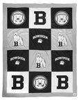 Large quilt with grey trim and panels in black, white, and grey, with Bowdoin imprints on each.