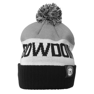 Children's cuffed beanie with black cuff, white center stripe, and grey top, black-white-and-grey pom and knit-in black BOWDOIN on white center band. Polar bear mascot medallion tab on cuff