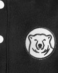 Closeup of embroidered polar bear medallion patch.