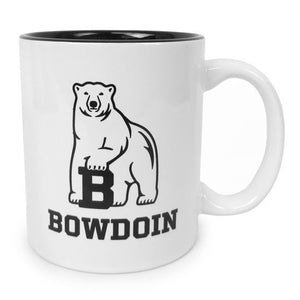 White coffee mug with black interior and polar bear mascot over BOWDOIN imprint.