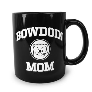 Black coffee mug with white imprint of BOWDOIN arched over a polar bear medallion over the word MOM.