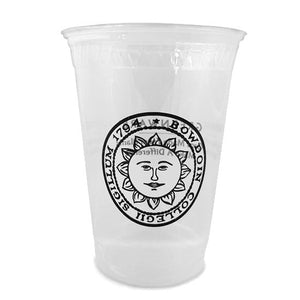 Clear plastic disposable cup with black imprint of Bowdoin sun seal on front.