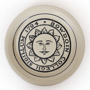 Natural round plate with large black Bowdoin college seal imprint.