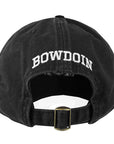 The back view of a black baseball cap showing the brass adjustable buckle closure and the word BOWDOIN embroidered in white over the opening.