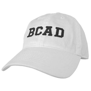 White ball cap with black embroidered BCAD on front.