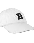 White ball cap with needlepointed black B on front.