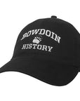 Black ball cap with white embroidery of BOWDOIN arched over a paw over HISTORY