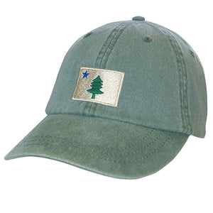 Faded green baseball hat with rectagle embroidered flag with a blue star in the top left corner and a green pine tree in the center.