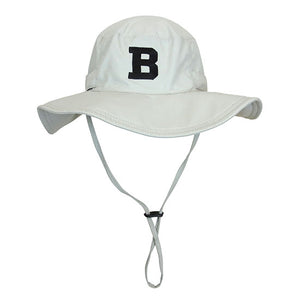 Beige wide brimmed hat with drawstring and black B patch on front.