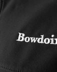Closeup of white Bowdoin embroidery on black soft shell jacket.