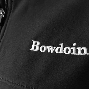 Closeup of white Bowdoin embroidery on black soft shell jacket.